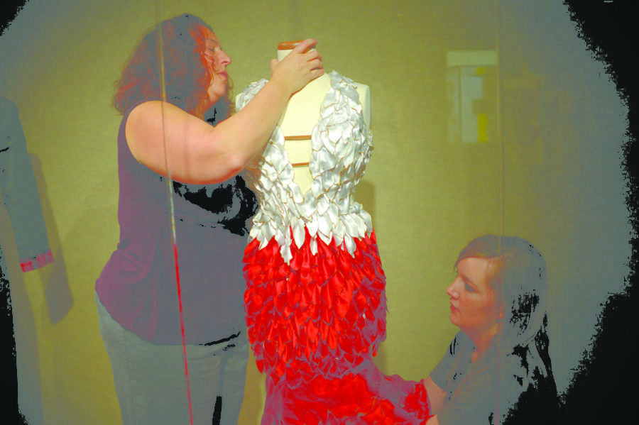 Students set up an exhibit from The Fashion Show in Morril Hall on Friday, April 25, 2013.
