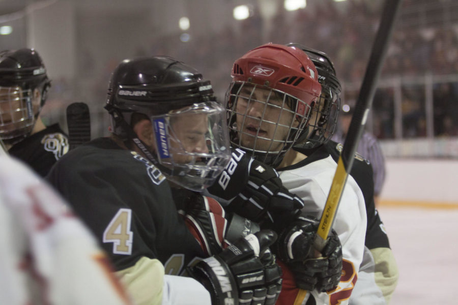 Joe Bueltel gets into a skirmish up against the glass during the
game against Oakland on Friday, Oct. 14. Iowa State beat Oakland
5-3 in game one of a two-game series. Bueltel had one assist but
was penalized six times during the game.
