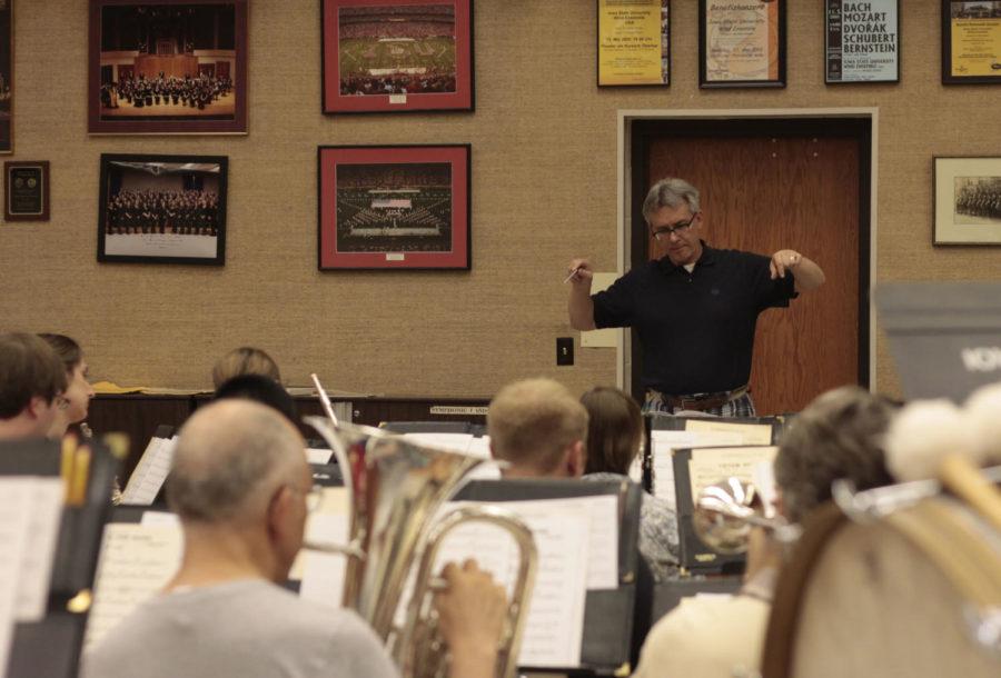 Professor and chair of the music and theatre department Michael Golemo conducts the Ames Municipal Band at a rehearsal in Music Hall on June 11, 2013. The band performs for free every Thursday at 8 p.m. at Bandshell Park in Ames.

