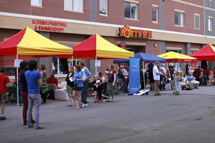 Business sponsor tents line Welch Avenue during Ames Summerfest 2013. Each tent provided different activities and information for visitors, as well as treats and games for children.
