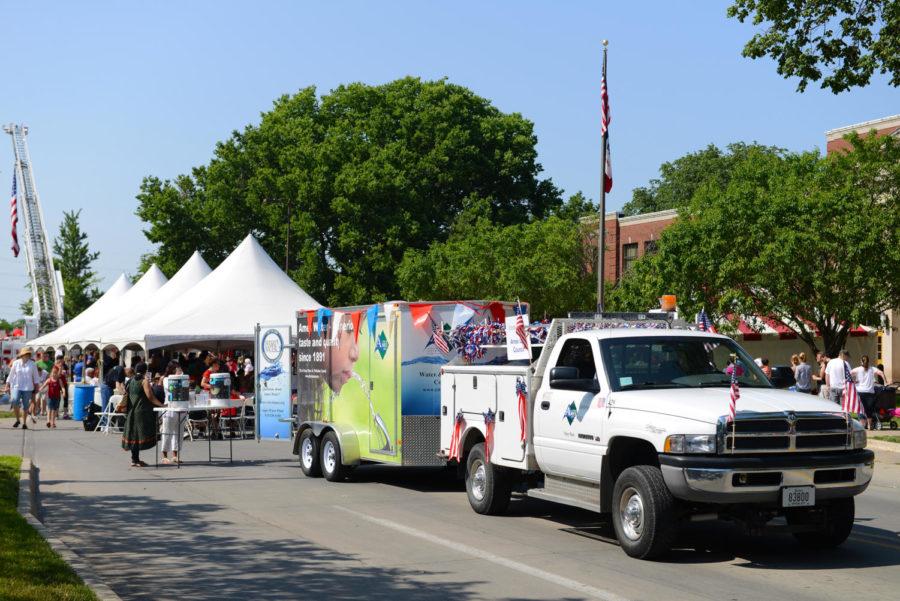 The Ames Water truck is parking in front of the city hall and serving drinking water to the community during Fourth of July Community Pancake Breakfast.