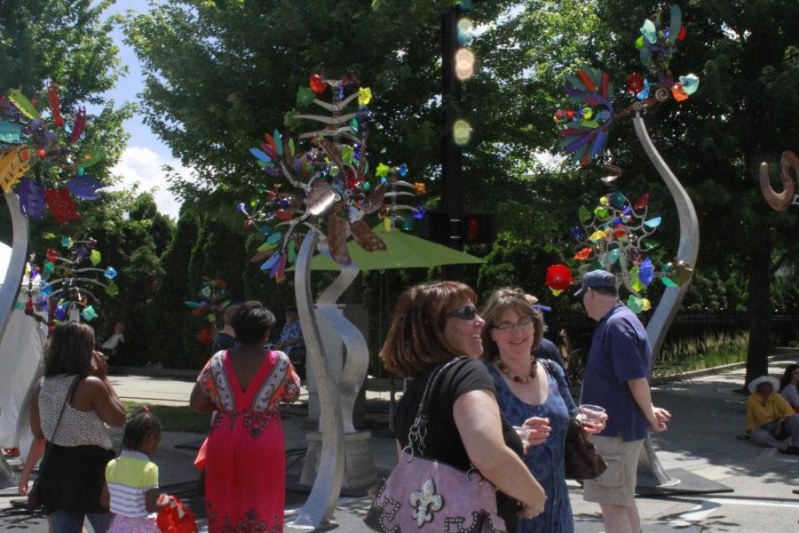 Attendees walk about Andrew Carsons kinetic sculptures.