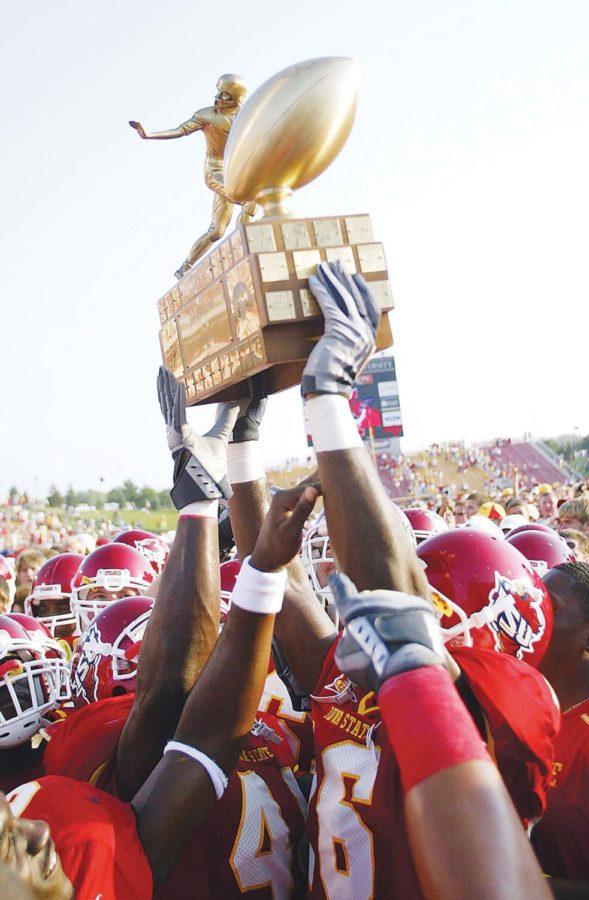 Holding the Cy-Hawk Trophy on Sept. 10, 2005.
