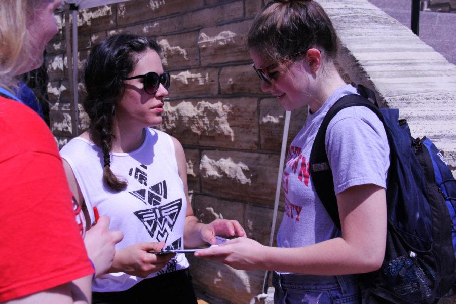 Monica Leier, senior in history, helps Sophie Deam, sophomore in political science, register to vote in Story County. The Carrie Chapman Catt Center for Women and Politics collaborated with the League of Women Voters of Ames to celebrate Womens Equality Day on Aug. 26, 2013. The holiday celebrates the anniversary of the ratification of the 19th Amendment, granting the women the right to vote.