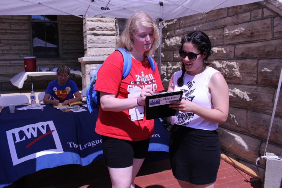 Monica Leier, senior in history, helps Rachael Longhenry, a junior in elementary education, register to vote in Story County. The Carrie Chapman Catt Center for Women and Politics collaborated with the League of Women Voters of Ames to celebrate Womens Equality Day on Monday, Aug. 26. The holiday celebrates the anniversary of the ratification of the 19th Amendment, granting the women the right to vote.