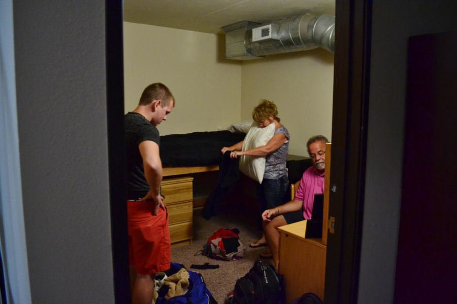 Sophomore Dustin Meyermann, left, moves into his room in Legacy Towers on Aug. 20. Meyermann is helped by Jim Savory and his mother Vicky Meyermann.