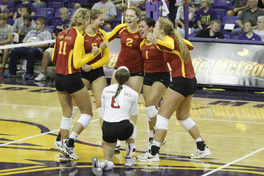 The Cyclone Volleyball team celebrates the win of their first set against UNI on Sept. 4, in Cedar Falls.