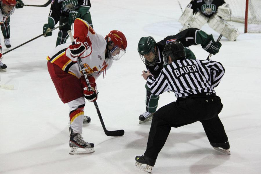 Cyclone forward Mark Huber and Ohio forward Jonathan Pietramala watch the puck as the referee drops it into play during the game Jan. 12 at Ames/ISU Ice Arena. The Cyclone hockey team was victorious over the Ohio Bobcats in the first of two games in a dramatic overtime win with a final score of 2-1. Cyclones are scheduled to play the Bobcats once more on Jan. 13.
