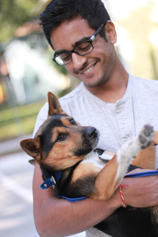 Parush Patel, senior in marketing, poses with his dog Max. Patel got Max a month ago. “It is nice to have company from my little buddy”.