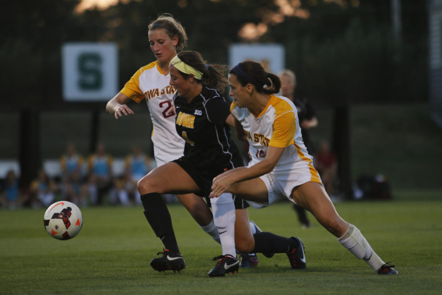 Freshman forward Koree Willer, No. 2, and senior midfielder Meredith Skitt, No. 14, fight off an Iowa player during Friday nights game at the Iowa Soccer Complex in Iowa City. The Cyclones lost to the Hawkeyes 3-0 and are now 3-2 in the season.