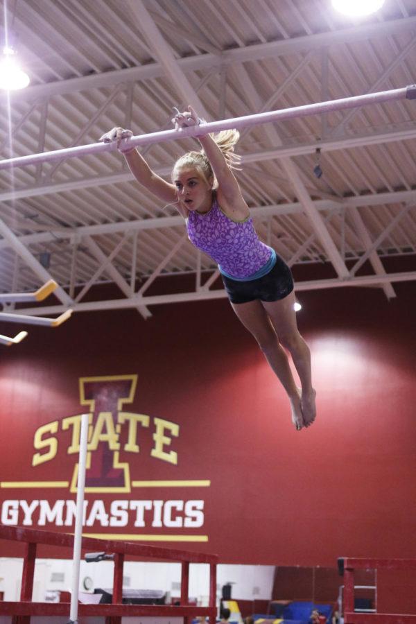 Kinesiology major Brooke Schweikert practices on the high bar during gymnastics class held in Beyer Hall on Wednesday, Sept. 25. 