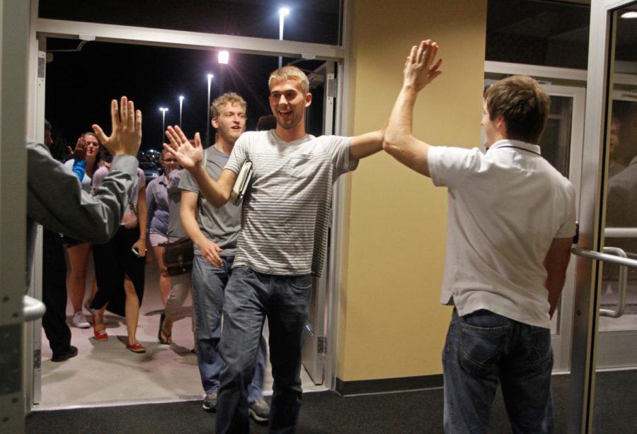 Students are greeted with high-fives as they make their way into Cornerstone Church of Ames for The Salt Company.