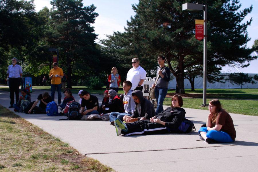 A crowd gathers in the free speech zone outside of Parks Library to listen to guest readers read excerpts from challenged and banned books, as part of Iowa States celebration of Banned Books Week.