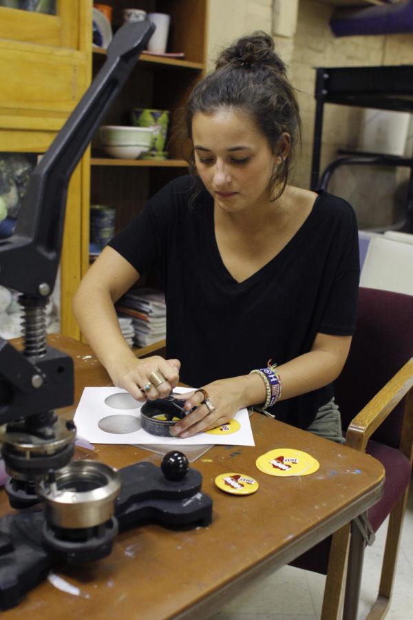 Meredith Whitlock, junior in journalism and mass communications and president of the Iowa State branch of Hope 4 Africa, makes buttons to promote the organization in the Workspace at the Memorial Union on Monday, Sept. 9.