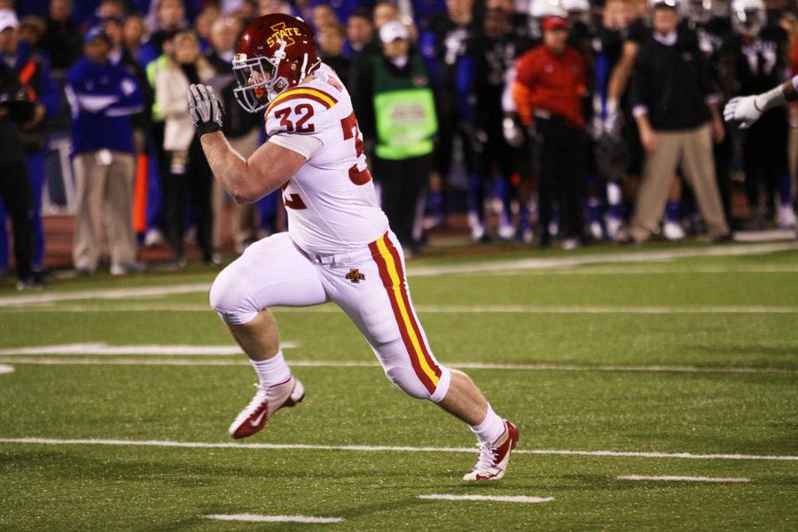No. 32 Jeff Woody runs with the ball after a pass from No. 12 Sam Richardson. Richardson played for the first time as quarterback during the the game against the University of Kansas on Saturday, Nov. 17, 2012.