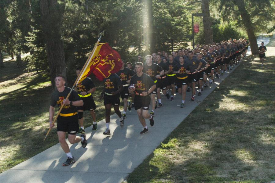 The ROTC team runs though the ISU campus in front of Catt Hall in the afternoon on Sept. 13.