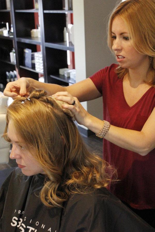 Stylist Krista Wrage prepares bride Molly Haberl hair to see what she would like her style to be on the big day.