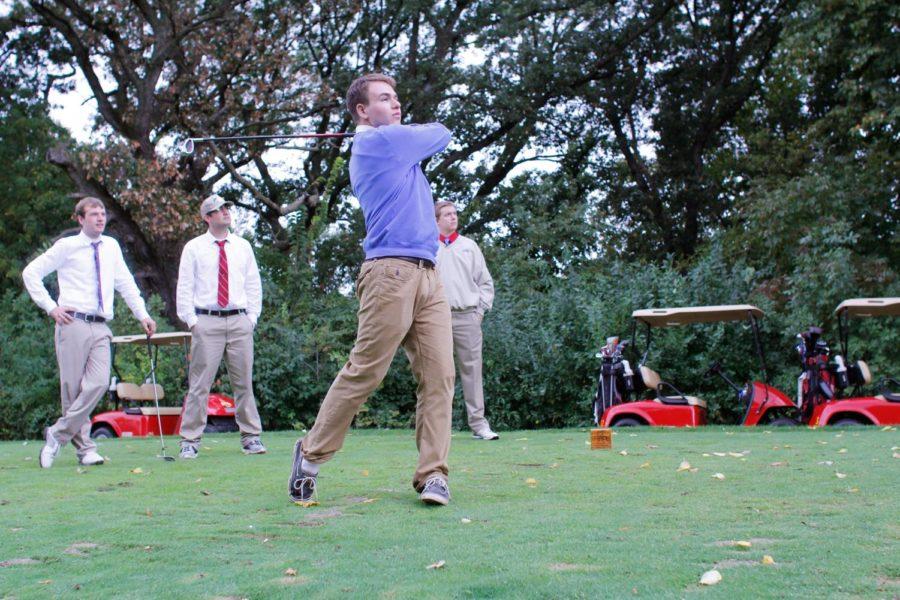 Trent Purdy, sophomore in marketing, swings and drives the golf ball down the course. Isaac Cowan, back left, sophomore in accounting; Derek Huser, senior in finance; and Matt Gray, senior in accounting, observe quietly on Saturday, Sept. 28,h at Veenker Memorial Golf Course.