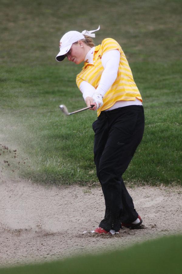 Freshman Cajsa Persson chips her ball out of the sandtrap during the Big 12 Golf Tournament on Saturday, April 20, 2013, at The Harvester.
