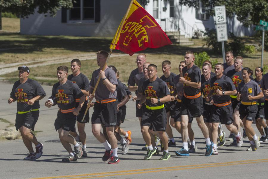 Members of the ISU Army ROTC group head out of Tama, Iowa on Friday afternoon. The group is carrying the game ball that will be played with in the 2013 Cy-Hawk football game.