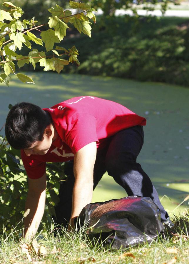 Josue Avila, sophomore in design, picks up trash on Sunday, Oct. 13, for Greeks Go Green lake cleanup at Lake LaVerne.