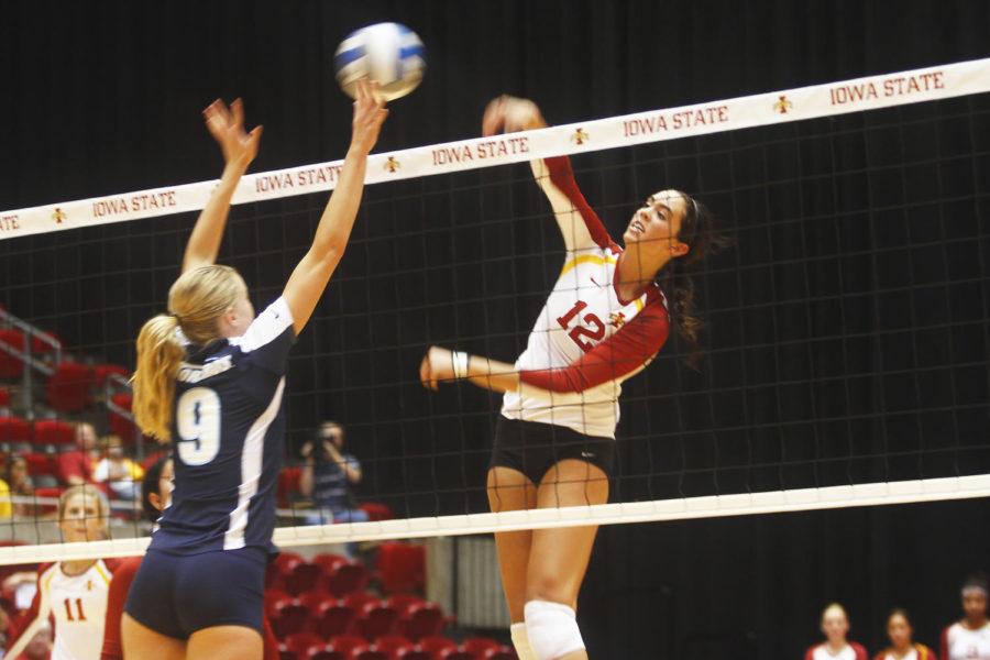 Middle hitter Tory Knuth jumps to hit the ball, which the San Diego team is unable to keep in play at Hilton Coliseum on Friday, Sept. 6.