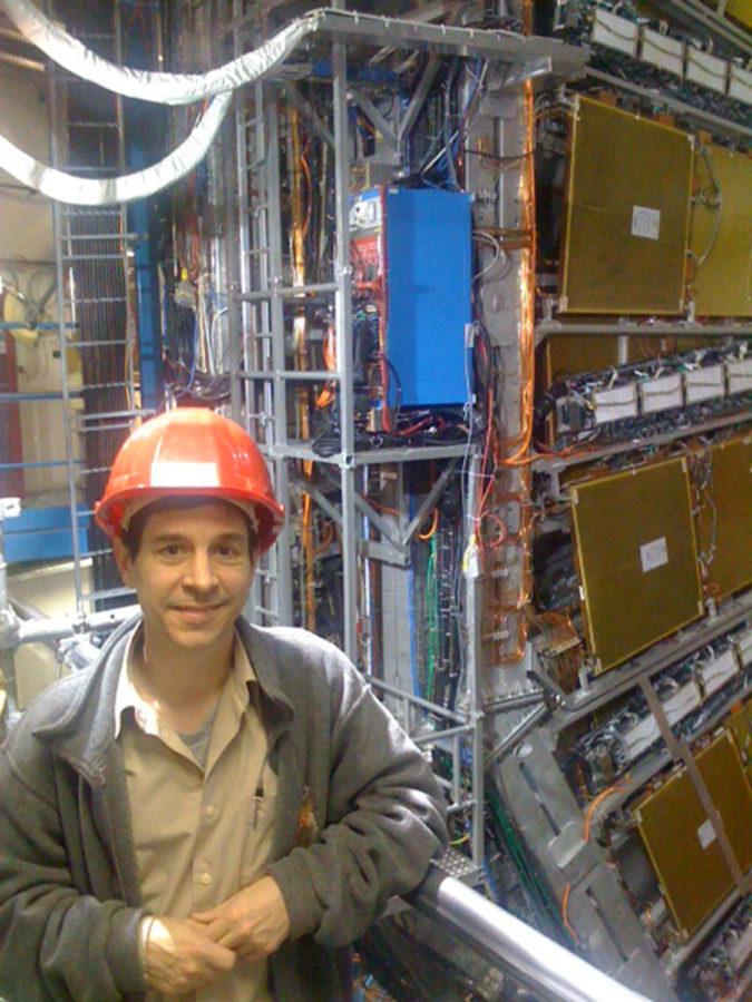 Jim Cochran, professor of physics and astronomy, stands in front of the ATLAS detector. Cochran was the principal investigator for the ATLAS experiment at Iowa State.