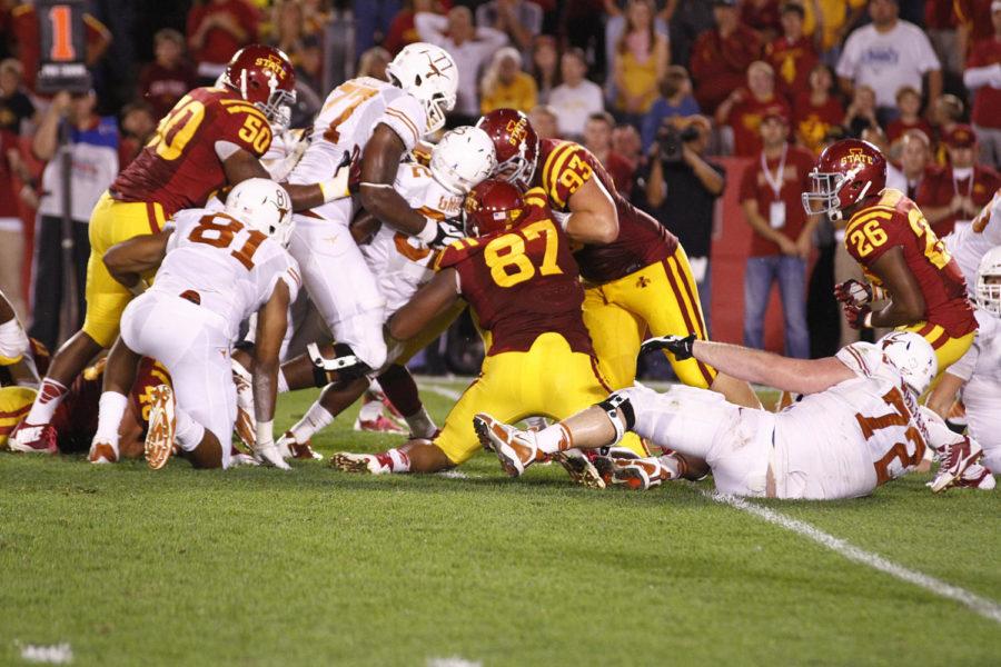 Texas sophomore running back Johnathan Gray gets swarm tackled by Iowa State defensive players at the goal line. Gray controversially lost the ball during the play. After review the officials ruled that Gray was down before the ball came loose.