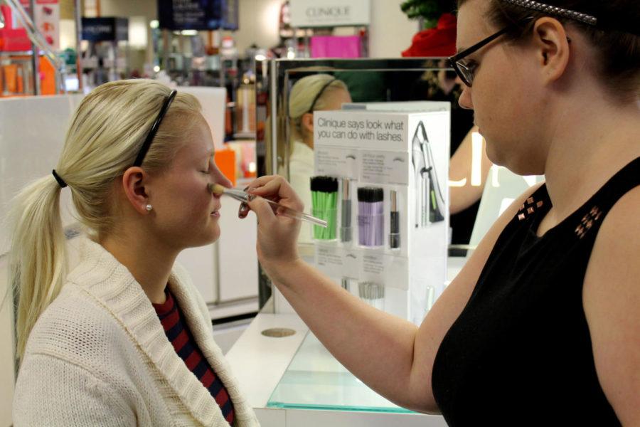 Maggie Hughes, right, consultant for Clinique in younkers in Ames, demonstrates how to apply the brand’s Moisture Surge CC Cream to Ashley Peters, sophomore in apparel, merchandising and design.