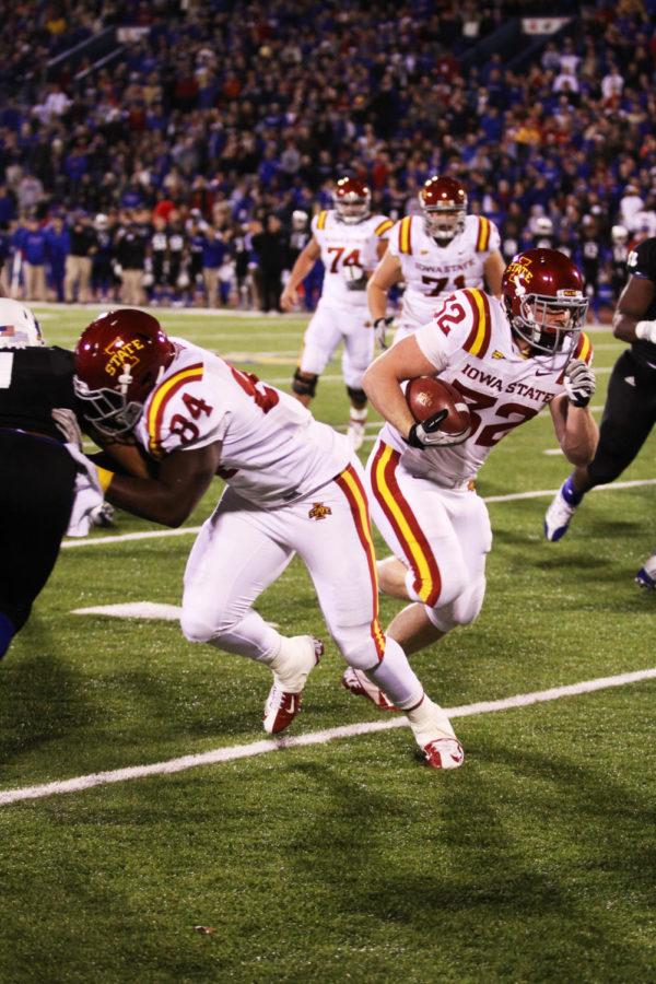 Iowa States No. 32 Jeff Woody sneaks by with the aid of his teammate, No. 84 Ernst Brun Jr. The game against the University of Kansas tallied a Cyclone win, with a final score of 51-23
