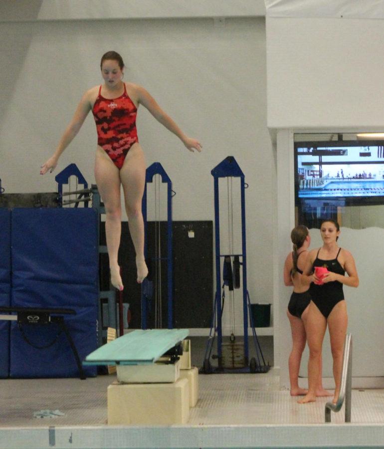Jessica Henderson, right, watches on as her teammate Elyse Brouillette starts her dive in the 1-meter event.