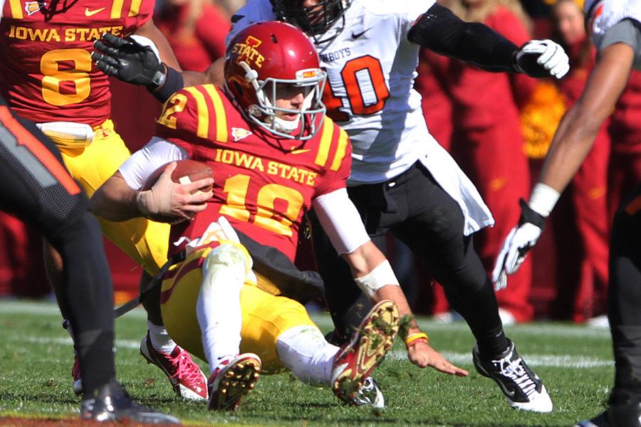 Redshirt sophomore Sam Richardson rushes the ball and slides just before he is injured during the second quarter against Oklahoma State on Saturday, Oct. 26, at Jack Trice Stadium. Richardson sat out for the rest of the game.