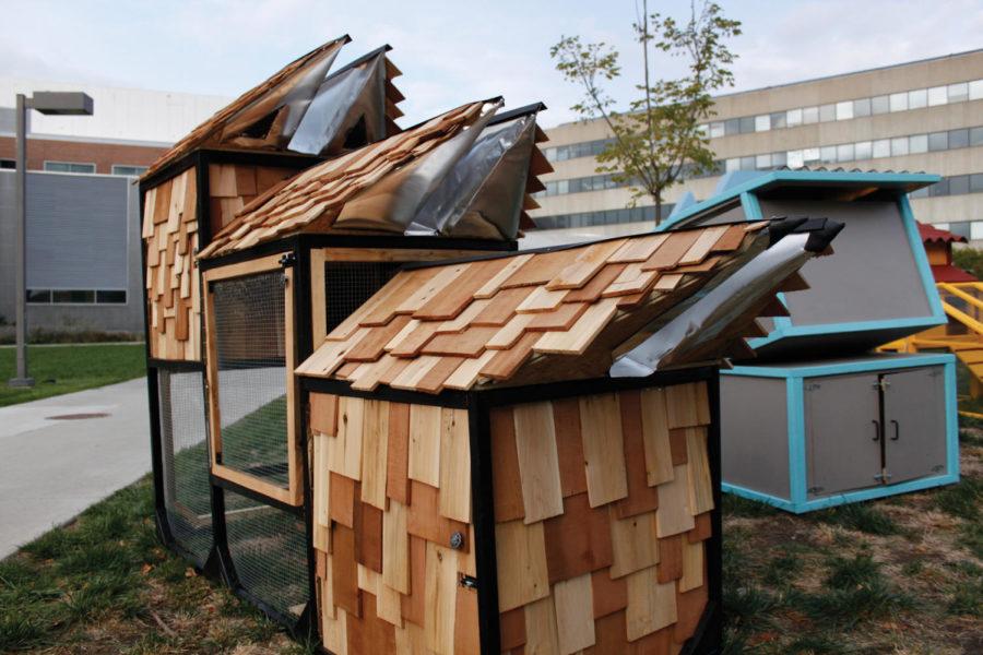 A collection of unorthodox chicken coops built by architecture students stand outside the College of Design. The coops were built to house three to five chickens and will remain standing until Oct. 25.