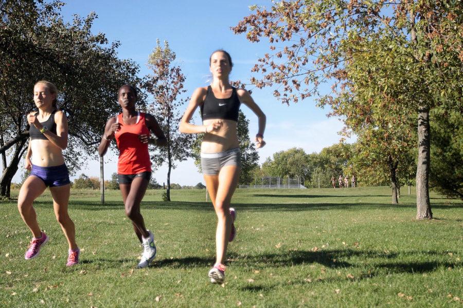 Sophomore Crystal Nelson runs along side freshmen Perez Rotich and Bethanie Brown in practice on Tuesday, Oct. 8.