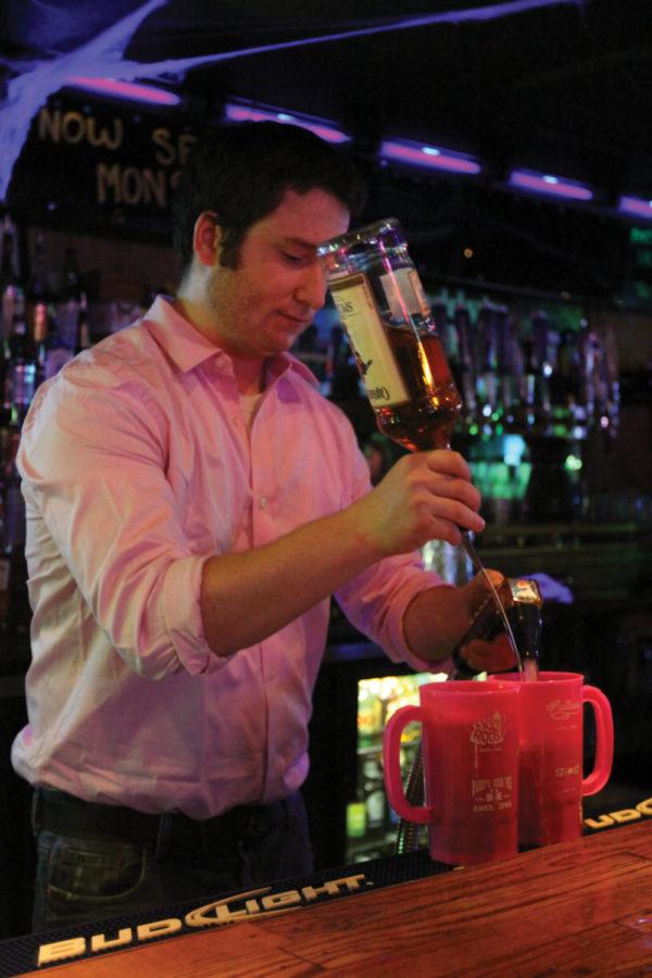 Joseph Hughes serves customers at Paddys during the 2012 Drink Pink Bar Crawl. Colleges Against Cancer sold pink mugs to attract peoples attention to Breast Cancer Awareness Month. File.