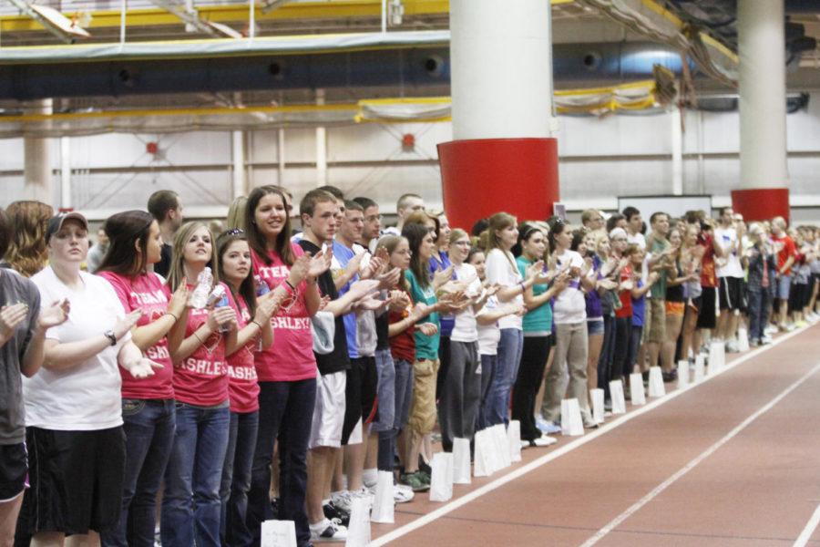 Participants in Iowa States Relay For Life line the track inside Lied Recreation Athletic Center to support cancer survivors taking the inaugural lap of the evening on Friday, March 23. Survivors led the relay for the first lap, then invited all other participants to join them in walking continuously for 12 hours. 
