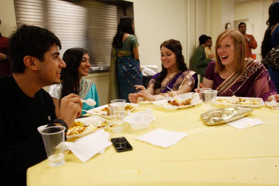 Kaitlin Heinen, right, senior in chemistry; Nicole Valderrabano, senior in aerospace engineering; Devika Tandon, senior in architecture; and Abhijit Patwa, junior in mechanical engineering, sit around and discuss cultural differences during the Diwali festival Saturday, Nov. 9, at the Methodist Church. Diwali is known as the festival of lights for Hindus.