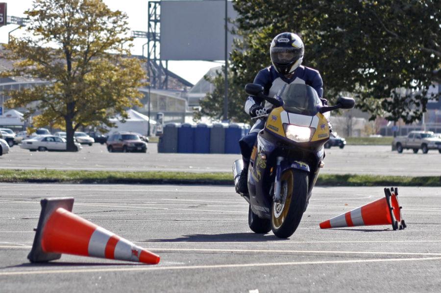 Allen Paczynski, senior in construction engineering, swerves around tipped construction cones as he navigates a course set up in the parking lot of Hilton Coliseum. Paczynski is a member of the ISU Motorcycle Club, which hosted CyTrax, a public timed riding event, on Nov. 2.
