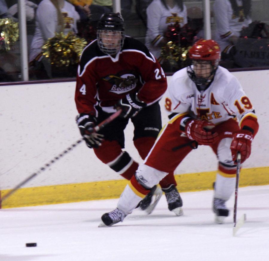 Senior Jon Feavel drives the puck in the game against the Minot State Beavers on Saturday, Nov. 16, at the Ames/ISU Ice Arena. The Cyclones won with a score of 4-1.