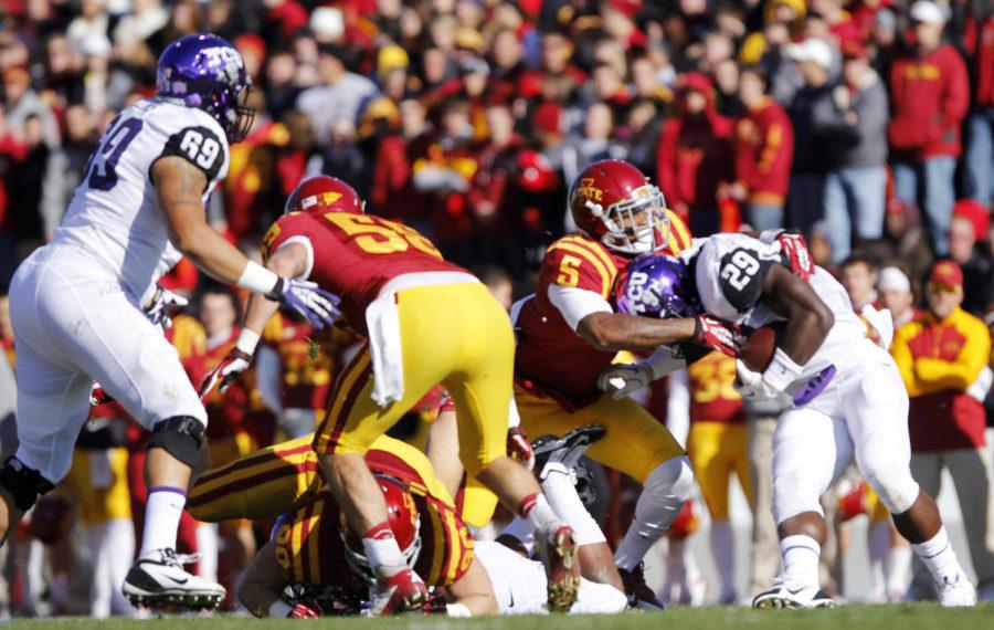 Redshirt senior defensive back Jacques WashingtonCQ tackles sophomore tailback Jordan Moore of TCU during the homecoming game on November 9, 2013 at Jack Trice Stadium. Washington had a total of eight tackles in the 17-21 loss.