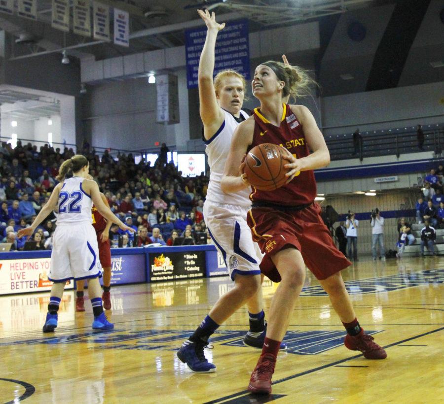 Senior forward Hallie Christofferson maneuvers around Drake defender Emma Donahue on Nov. 24 at the Knapp Center. Christofferson led the team in scoring with 25 points in the 89-47 road win.