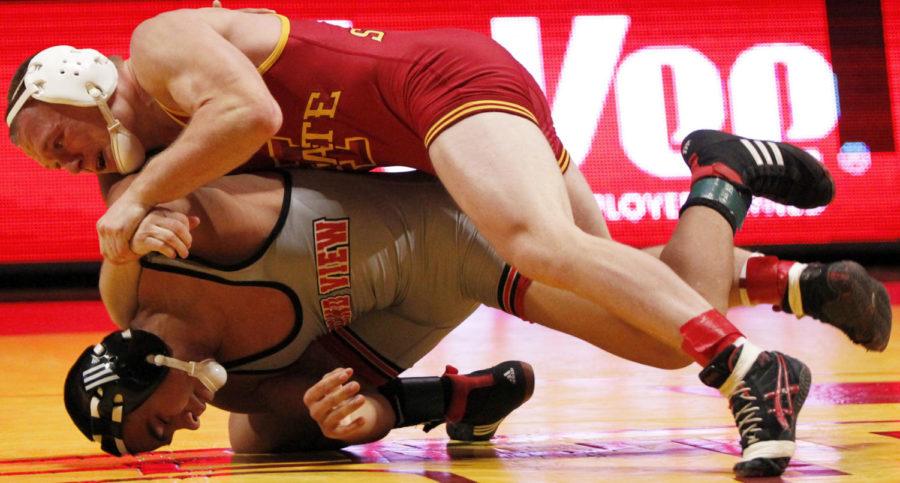 Redshirt freshman Kyle Larson throws his opponent, Grand Views Ernesto Escobar, down to the mat in their 125-pound matchup on Nov. 7 at Hilton Coliseum. Larson pulled off a 14-3 win, giving the Cyclones their first four points in the 22-18 win.