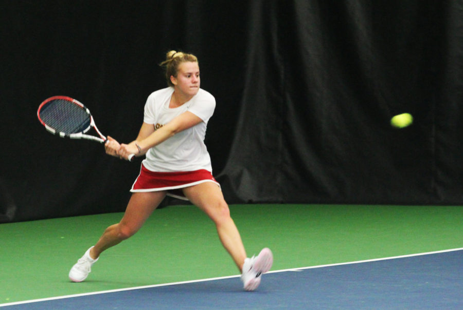 Junior Emma Waites prepares to return the ball during the meet against Texas Christian University on Sunday, March 17, 2013, at Ames Racquet & Fitness.
