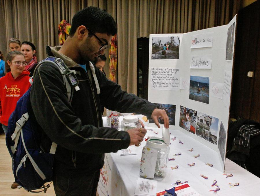 Kiran Rane, junior in electrical engineering, donates to Hearts for the Philippines at the International Bazaar on Monday, November 18, 2013.
