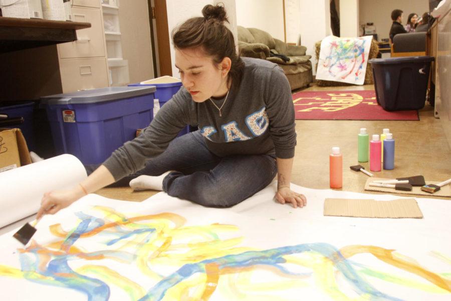 Katie Wilson, freshman in chemical engineering, makes banners for Fall Fest on Wednesday, Nov. 13, at Friley Hall.