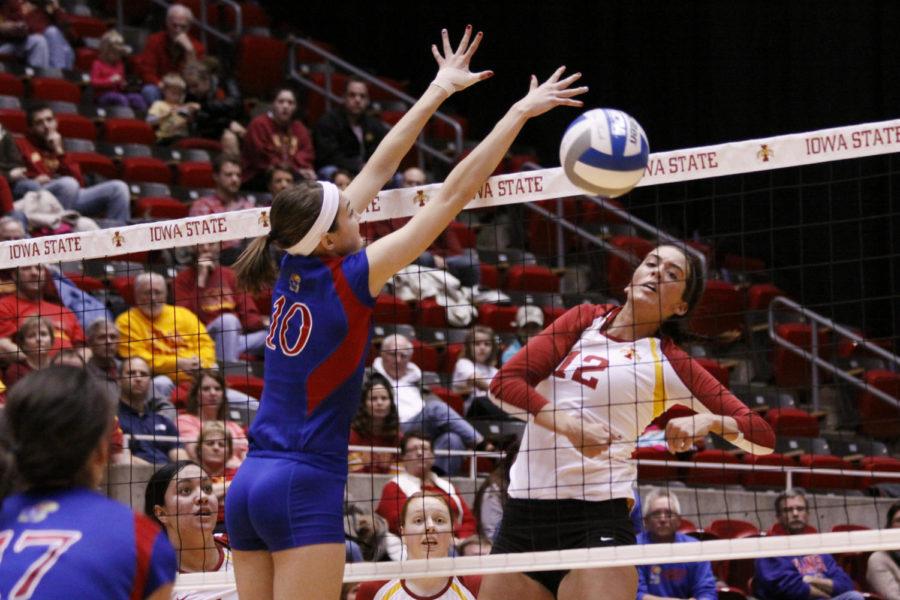 No. 12 Tory Knuth spikes the ball into the Jayhawk defense on Wednesday, Nov. 20, at Hilton Coliseum.