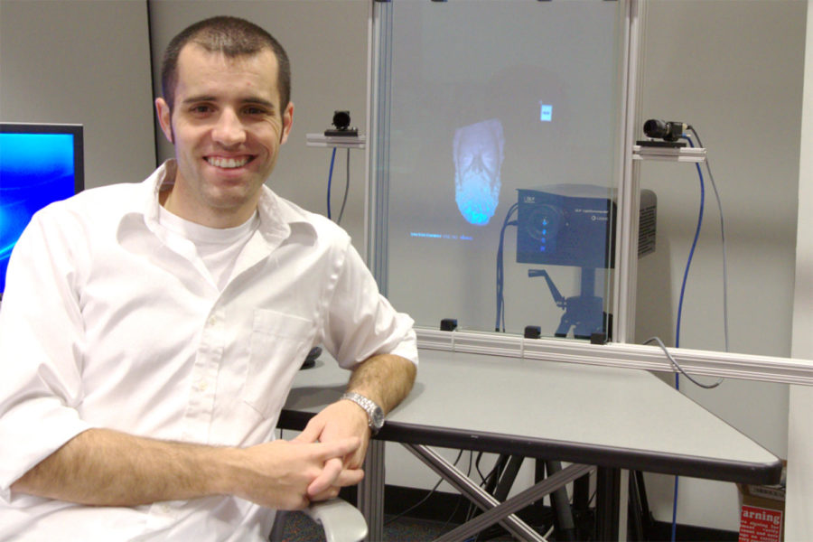 Nikolaus Karpinsky, graduate research assistant, explains how his 3-D teleconferencing system works.