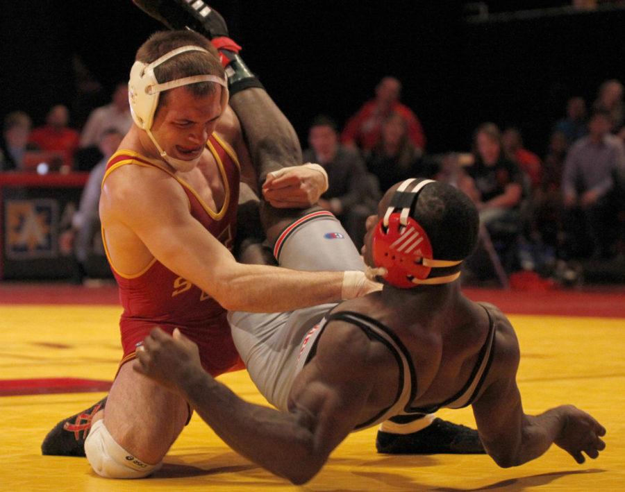 Redshirt senior John Nicholson throws Grand Views Quinten Haynes to the mat in their 157-pound matchup on Nov. 7 at Hilton Coliseum. Nicholson pinned Haynes to the mat to seal a victory in his matchup, helping the Cyclones to a 22-18 win.