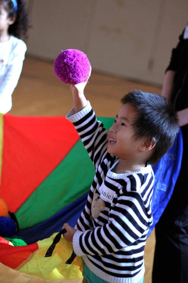 Along with other preschoolers, Daniel enjoyed playing with the parachute as the kids exercised in the 202 gym at Forker Hall for 30 minutes on Thursday, Nov. 14. 