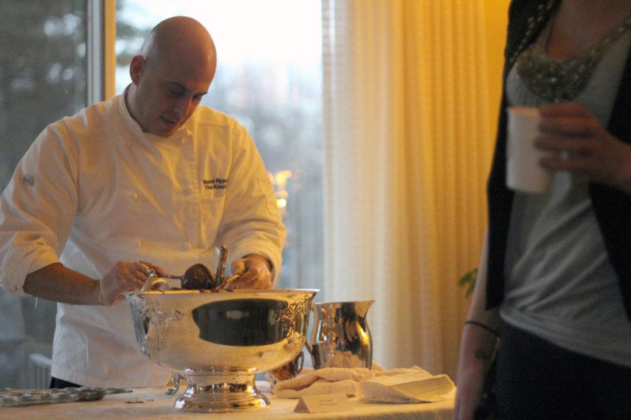 Knoll chef Anastasios Kyprianos, also known as Tasos, serves the Knoll Hot Chocolate during ISU First Lady Janet Leath's open house tour of The Knoll as a part of Winterfest.